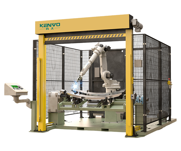 A robot cell with a yellow overhead door frame and perimeter mesh guarding.