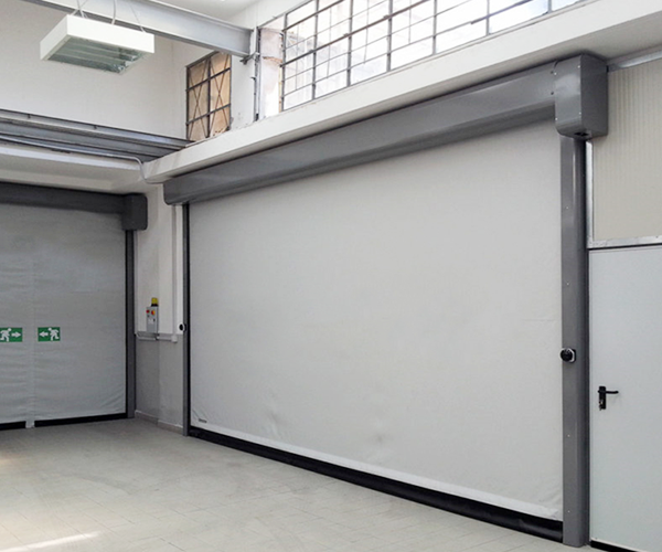 A large white rolling curtain installed at a workshop opening.