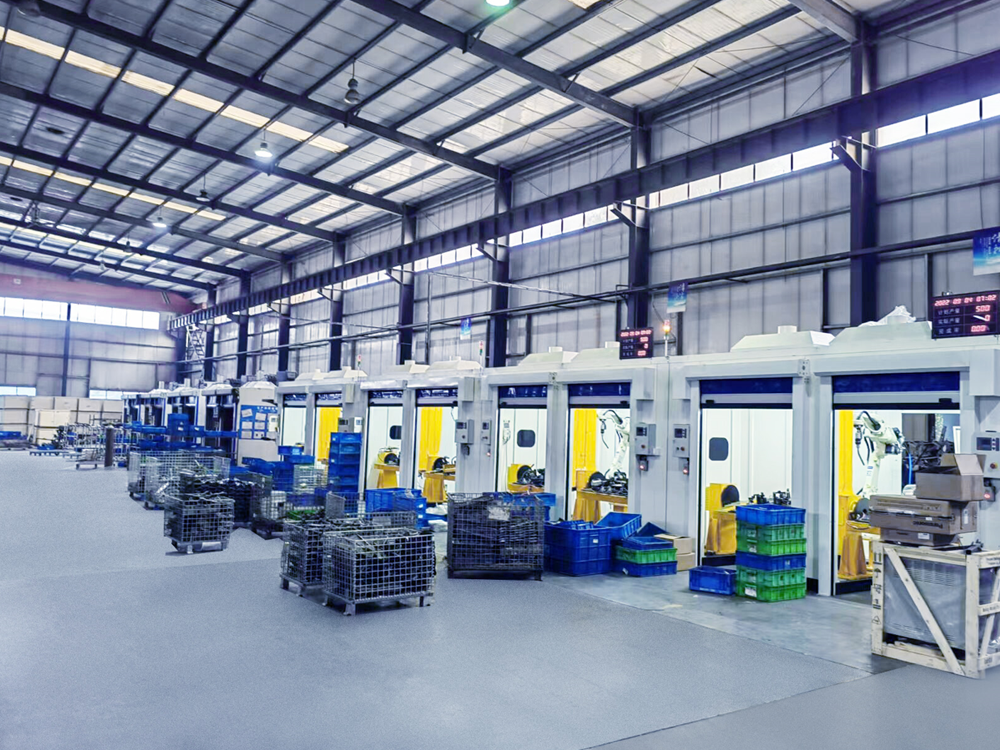 A production aisle lined with enclosed welding-cell openings.